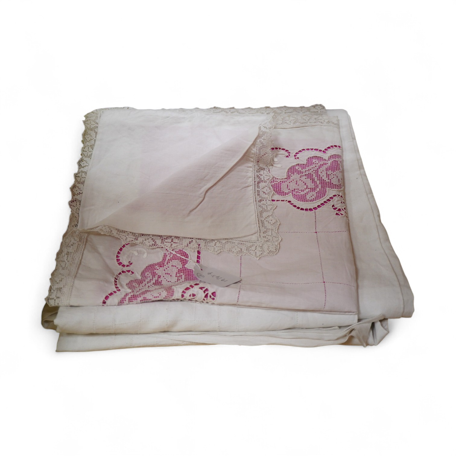A late 19th / early 20th century continental fine linen top sheet and near matching square pillowcase. The sheet designed with an ornate turn back with a fillet putti inset, fillet bird insets, a cut work embroidery cart